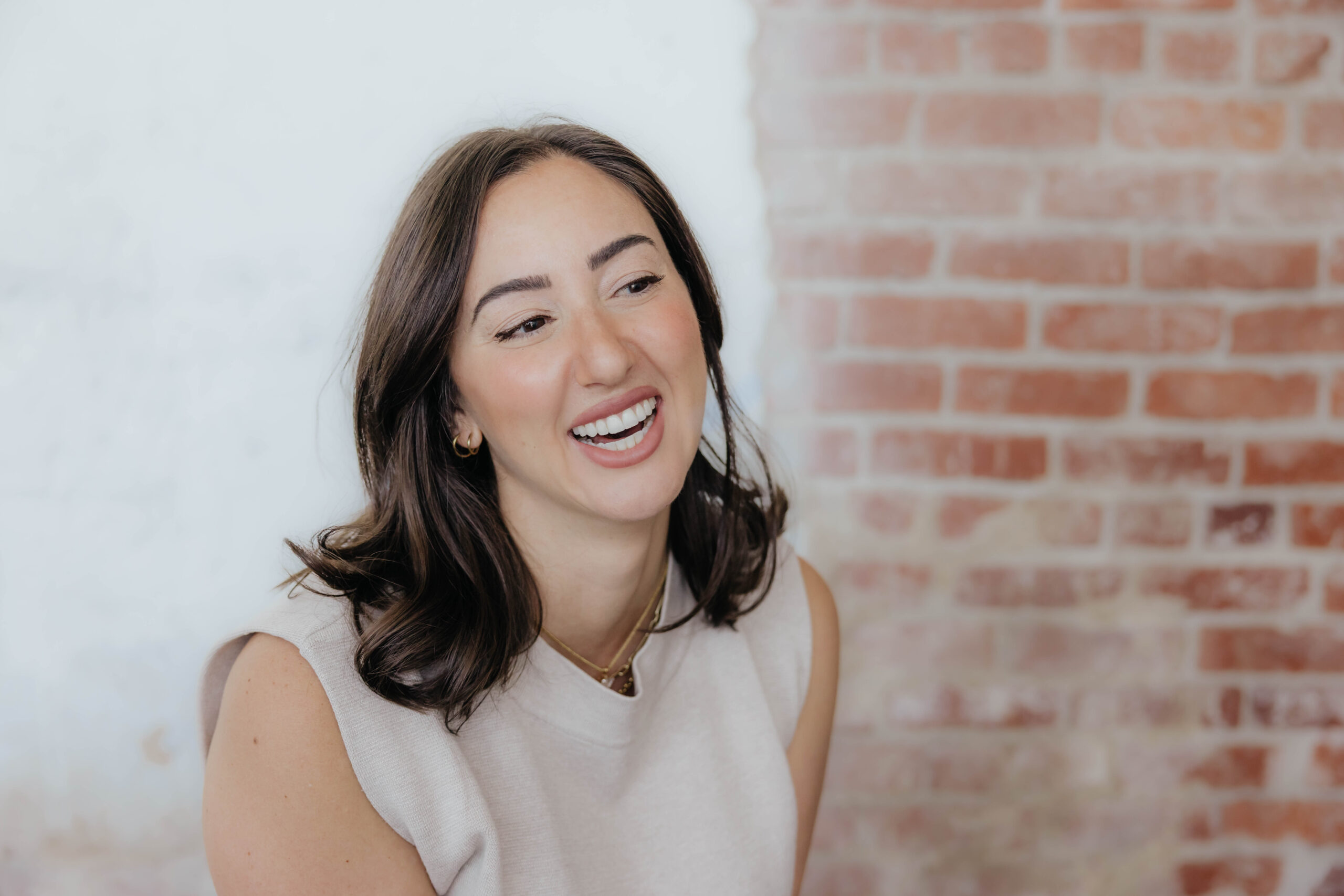 A woman smiling confidently after professional teeth whitening treatment from Santucci Orthodontics