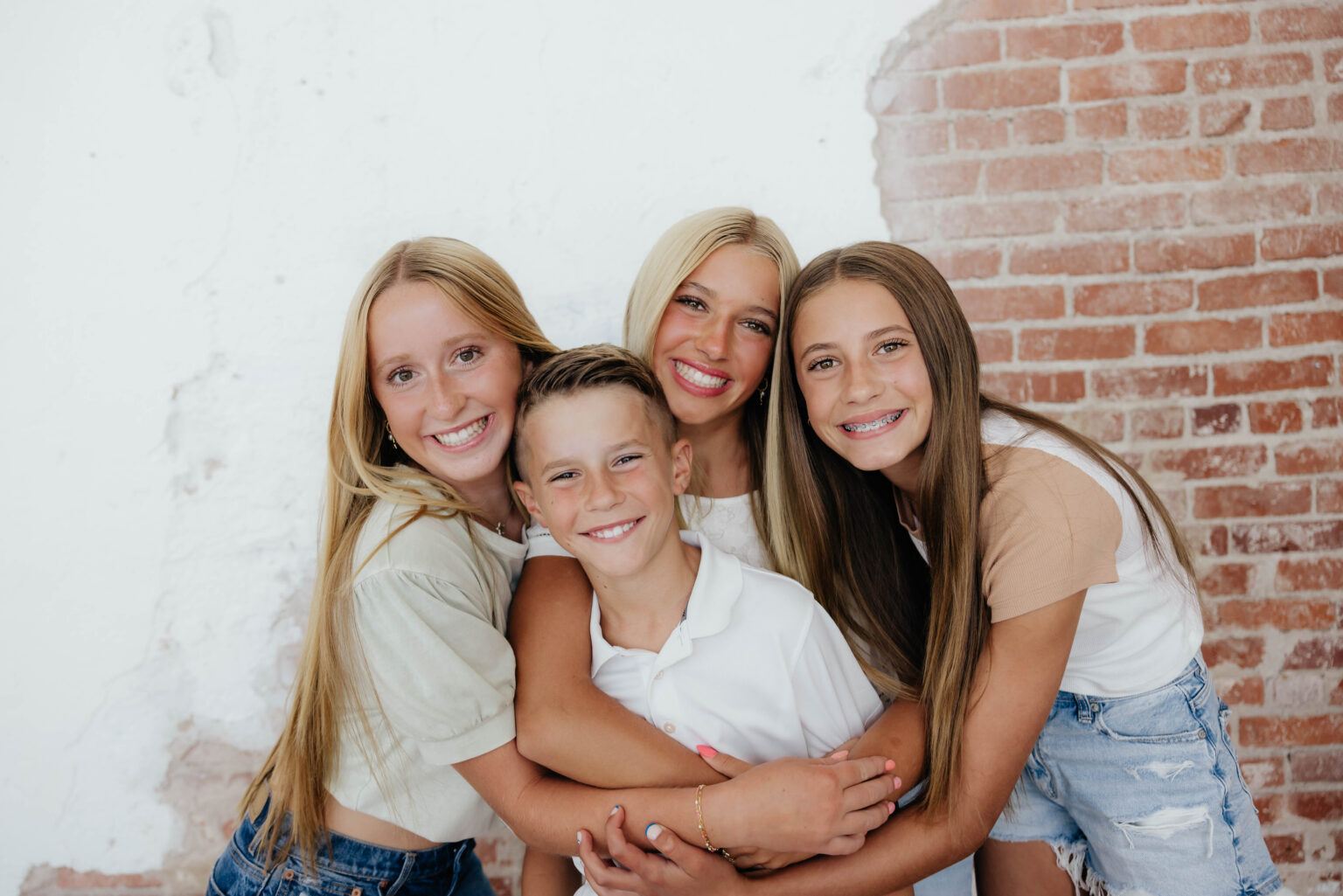 A group of teens smiling together, showing confident smiles after braces or Invisalign treatment