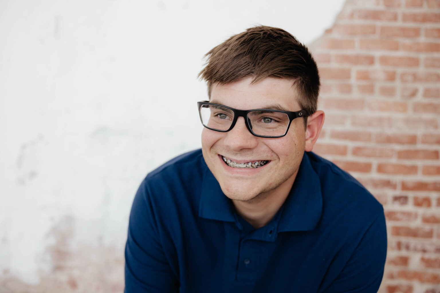 Teen boy smiling with metal braces during orthodontic treatment