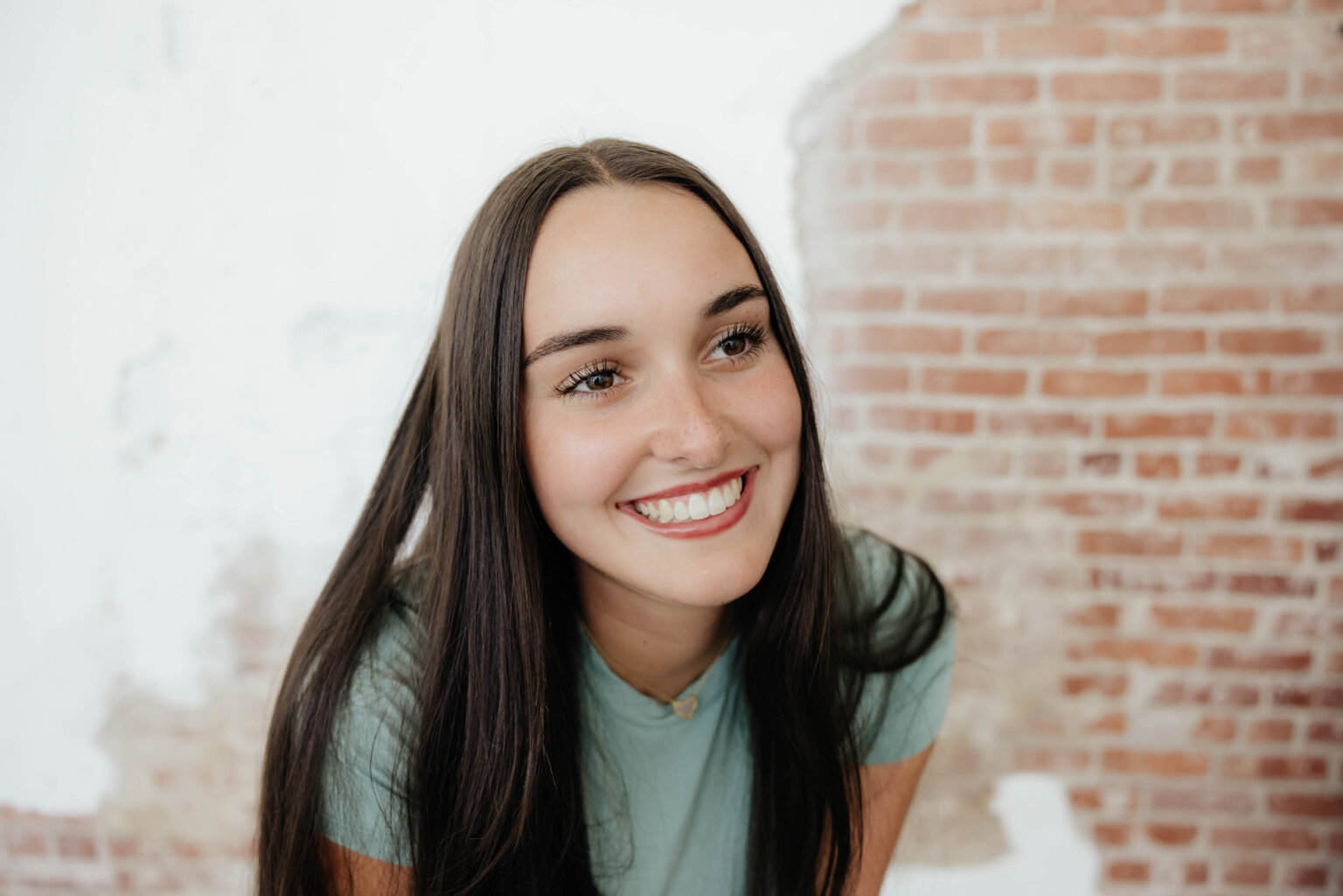 Woman smiling after receiving orthodontic work