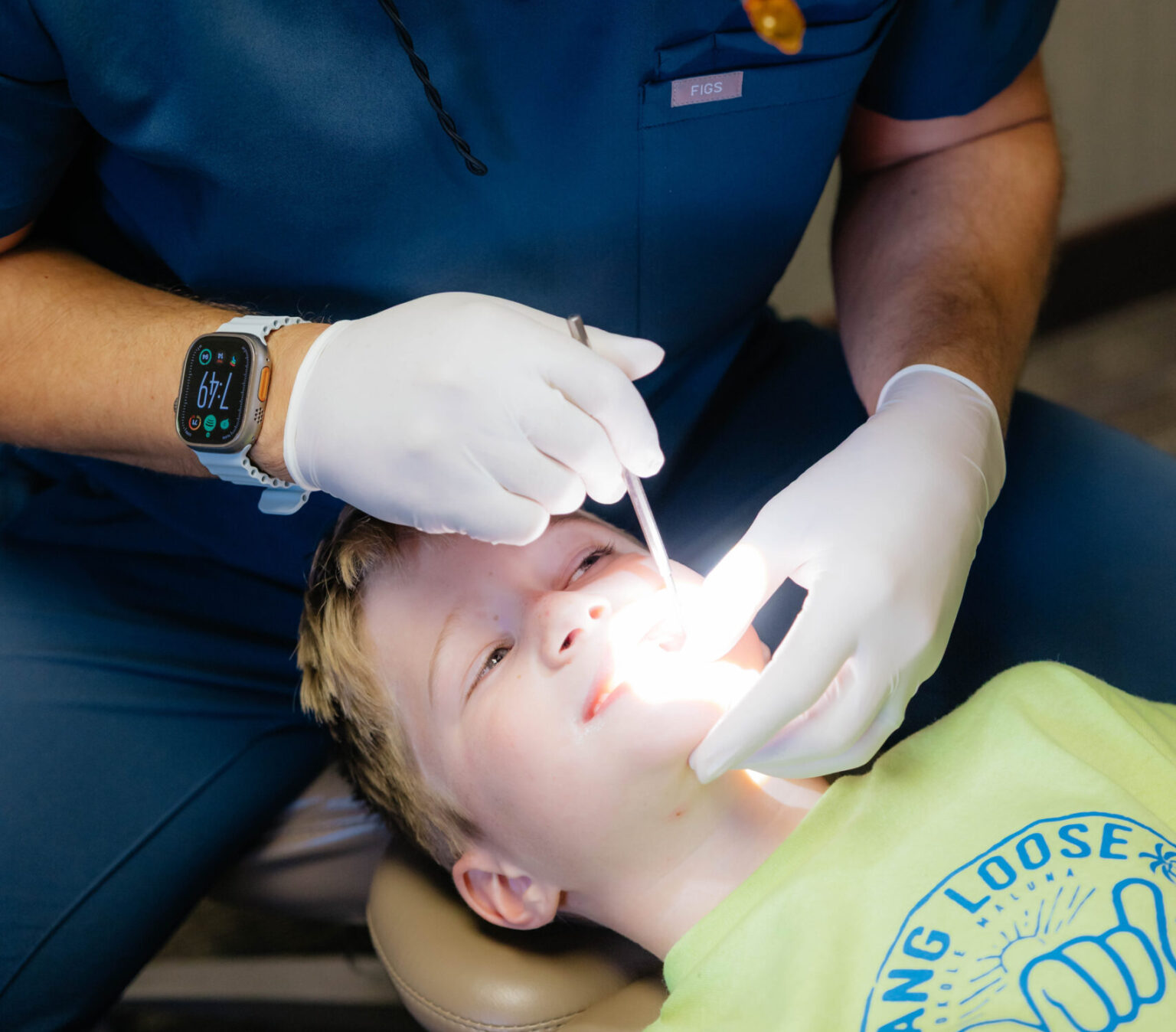 An orthodontist checking up on a child